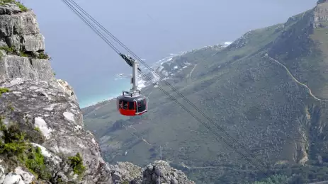 Red and black cable cart ascending at Table Mountain, Cape Town