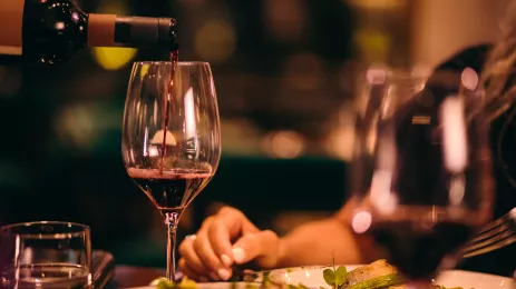 Close-up of red wine being served at fine dining restaurant