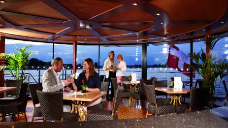 The Lido Bar aboard the MS Lord Byron with couples enjoying a drink