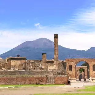 Ruins of Pompeii and a distant view of  Mount Vesuvius volcano in Italy