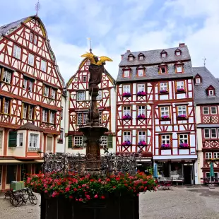 Beautiful Market Square with fountain, flowers and half timbered buildings in Bernkastel-Kues, Germany