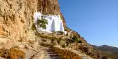 Rock steps heading towards white Monastery of the Virgin Mary in Greece