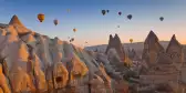 Hot air balloons rising up in the sky, in Cappadocia, Turkey.