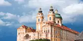 A distant view of Melk abbey on a rocky outcrop above the Danube river, Austria