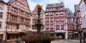 Beautiful Market Square with fountain, flowers and half timbered buildings in Bernkastel-Kues, Germany