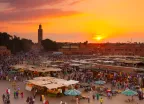 Jamaa el Fna market square at golden hour in Marrakesh, Morocco.