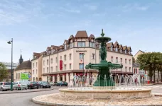 Exterior of Hotel Normandy with water fountain in Vernon, France