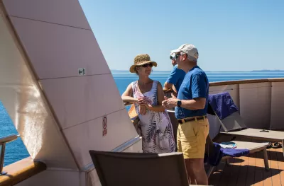 Mature friends talking and smiling  on board the Il Mare yacht