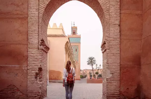 woman tourist in Marrakesh, Ilslam door view of Koutoubia mosque- Morocco