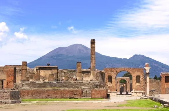 Ruins of Pompeii and a distant view of  Mount Vesuvius volcano in Italy