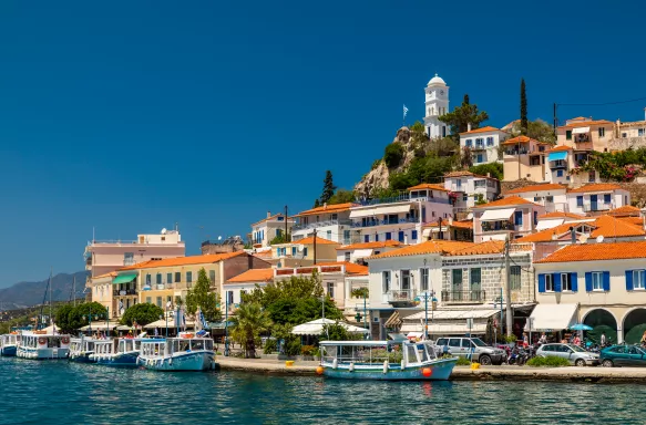 Poros Island and harbour with tour boats and houses in Greece