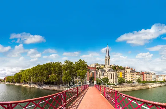 Pedestrian Saint Georges footbridge and the Saint Georges church in Lyon, France
