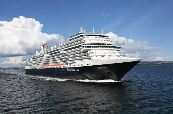 Exterior of the MS Koningsdam in motion along the sea, a Holland America Line ship