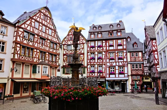 Beautiful Market Square with fountain, flowers and half timbered buildings in Bernkastel-Kues, Germany