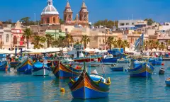 Traditional colourful eyed boats Luzzu at harbour in Marsaxlokk, Malta