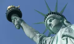 Close-up of the Statue of Liberty against a blue sky in New York