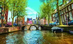 Water canal with traditional houses in Amsterdam