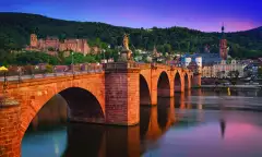 The old bridge in Heidelberg city and colourful evening sky in Germany