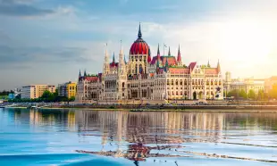 The Hungarian Parliament building over the Danube river at sunset in Budapest, Hungary