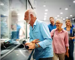 A happy elderly couple validating tickets at an airport