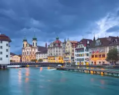 The Reuss River with surrounding buildings during a stormy evening in Lucerne, Switzerland