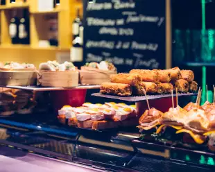 Several trays presented with a variety of Spanish tapas on the bar counter