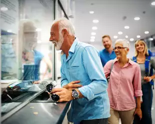 A happy elderly couple validating tickets at an airport