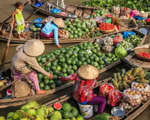 Women selling fruits on floating market on Mekong River in Delta,Vietnam