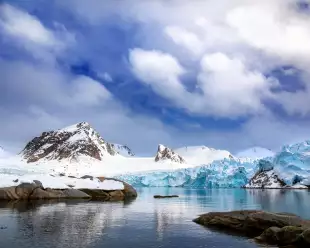 Mountains, snow and blue glacial ice in Svalbard 