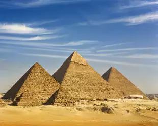 Desert view of the Great Pyramids of Giza under a clear sky