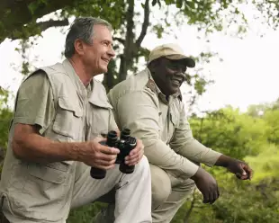Senior man and Safari guide man smiling together