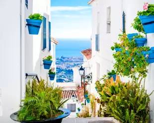 Narrow street in Mijas tourist town of the white villages in Andalusia, Spain