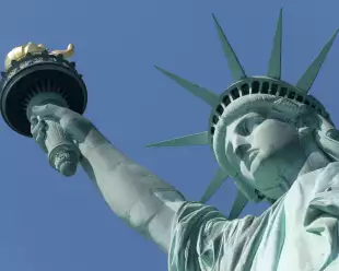 Close-up of the Statue of Liberty against a blue sky in New York