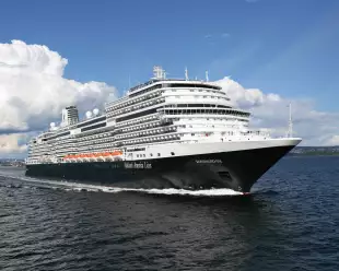 Exterior of the MS Koningsdam in motion along the sea, a Holland America Line ship