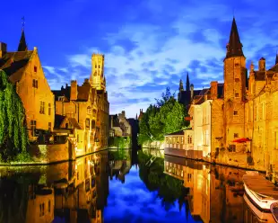 The Rozenhoedkaai canal and Belfort tower at twilight in Bruges