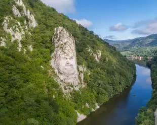 A large rock sculpture of decebalus overlooking the Danube River gorge 