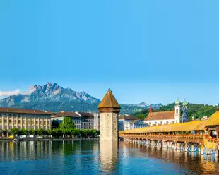Scenic panoramic view of Lucerne, Switzerland with Chapel bridge or Kapellbrucke and Pilatus mount with clear blue sky during summer