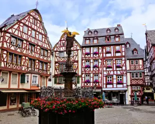 Beautiful Market Square with fountain, flowers and half timbered buildings in Bernkastel-Kues, Germany