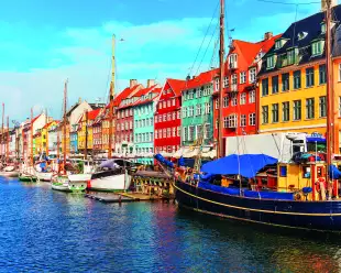 Nyhavn pier with colourful buildings, ships, yachts and other boats in the Old Town of Copenhagen, Denmark.