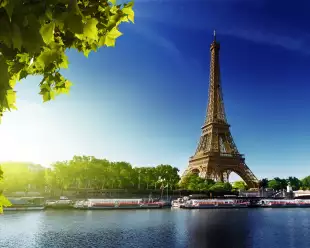 The River Seine and the Eiffel Tower during sunrise in Paris, France