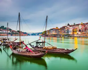Porto cityscape on the Douro River with traditional Rabelo boats in Portugal