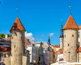 Two round guard towers of Viru Gate against bright blue sky in Tallinn, Estonia. 
