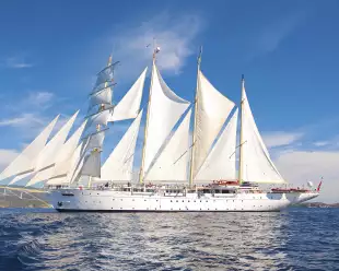 Exterior of the Star Clipper tall ship sailing under a blue sky