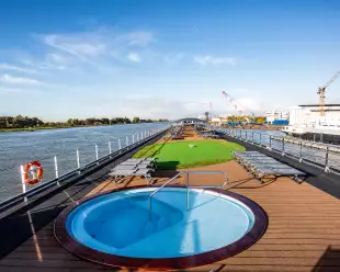 Sun deck with mini golfing area and round pool aboard the Thomas Hardy ship