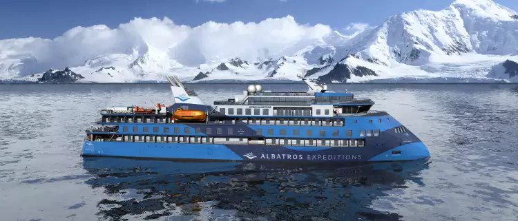 Exterior of the Ocean Albatros ship with snowy mountains in background
