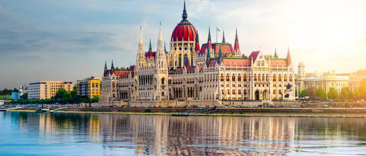 The Hungarian Parliament building over the Danube river at sunset in Budapest, Hungary
