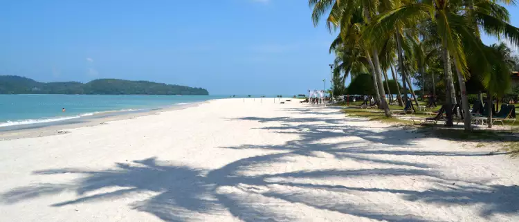 Pantai Cenang beach with white sands and palm trees in Langkawi, Malaysia