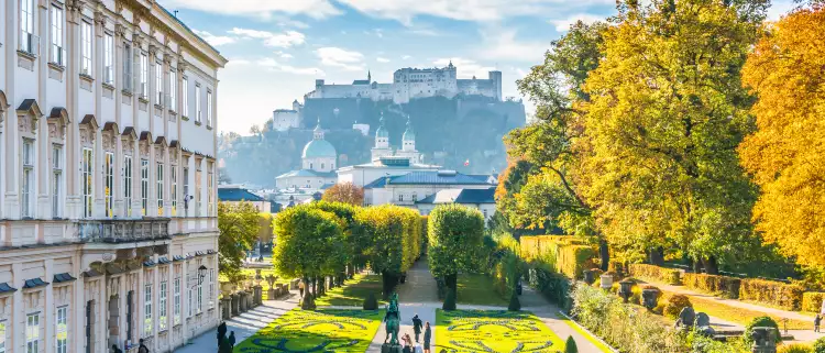 Beautiful view of famous Mirabell Gardens with the old historic Fortress Hohensalzburg in the background in Salzburg, Austria