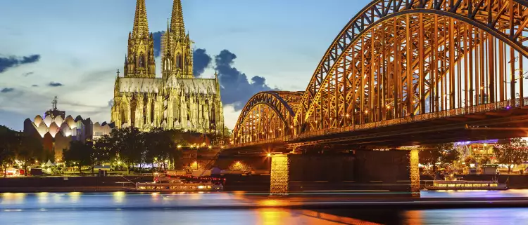 Cologne Cathedral and Hohenzollern bridge illuminated in Cologne, Germany