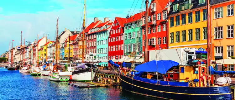 Nyhavn pier with colourful buildings, ships, yachts and other boats in the Old Town of Copenhagen, Denmark.